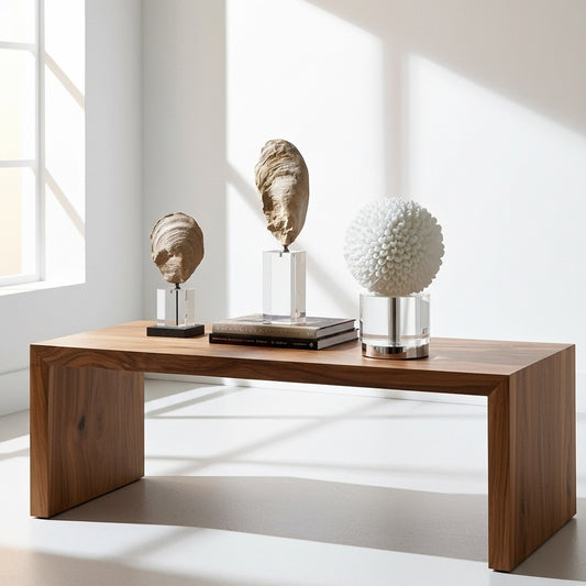 Two large oyster sculptures on clear stands against a white background