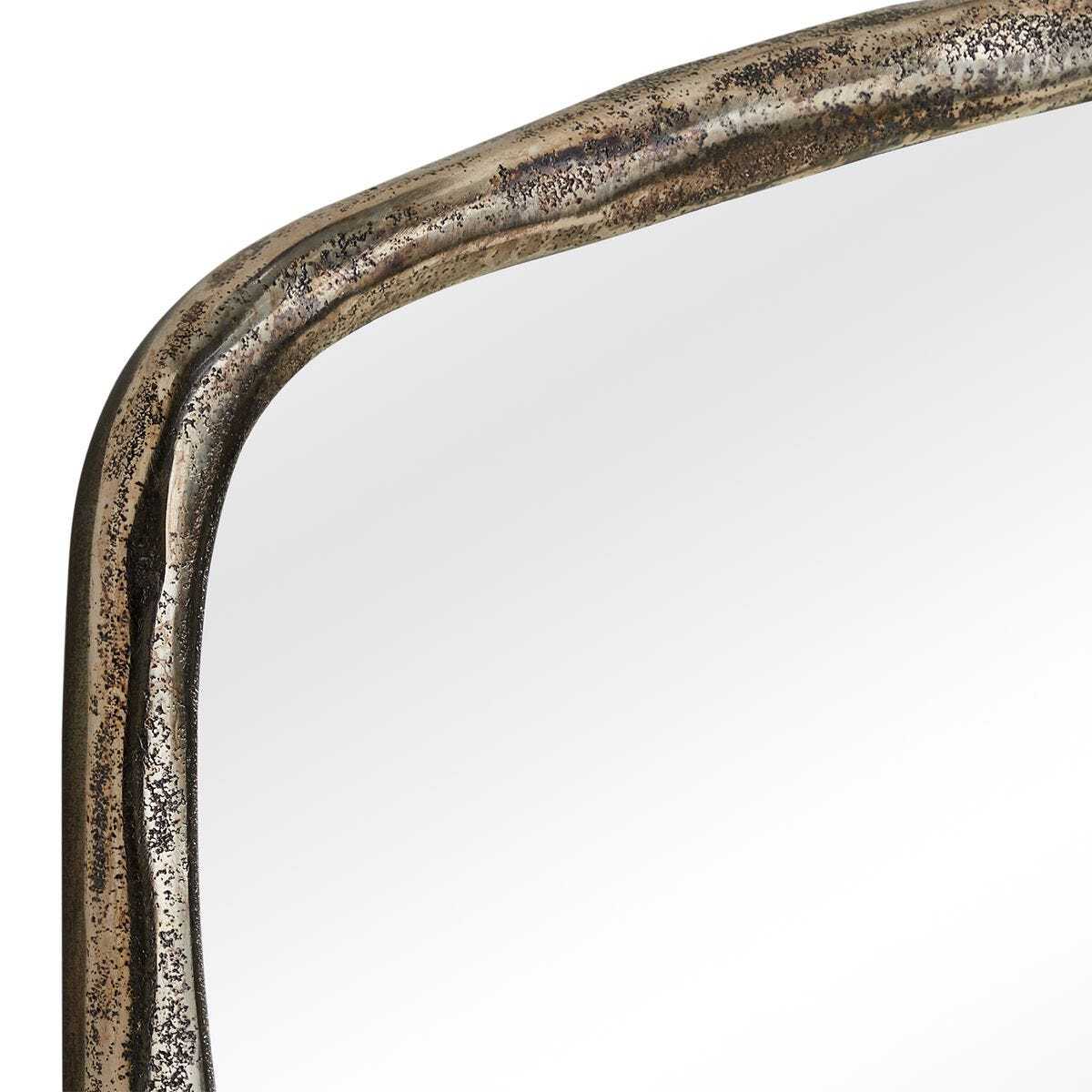 Close-up of a mirror with a metallic frame on a white background