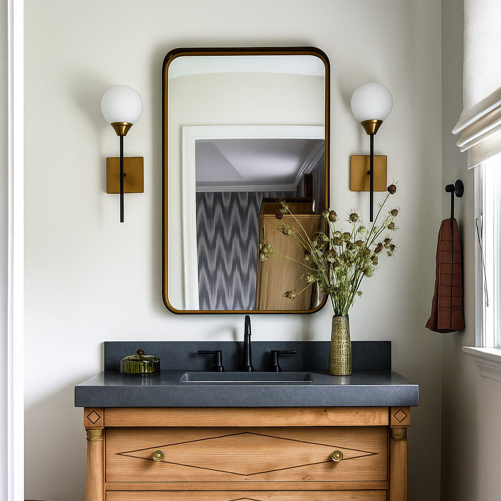 Bathroom vanity with wooden cabinet, gray countertop, and mirror.