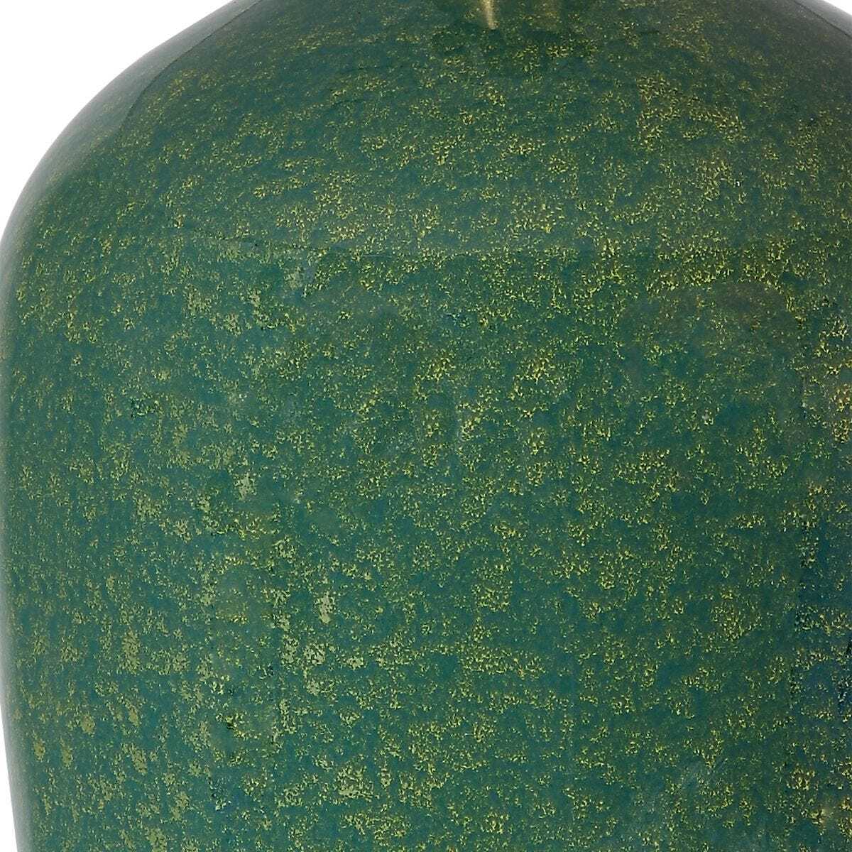 Close-up of a green textured surface with gold specks