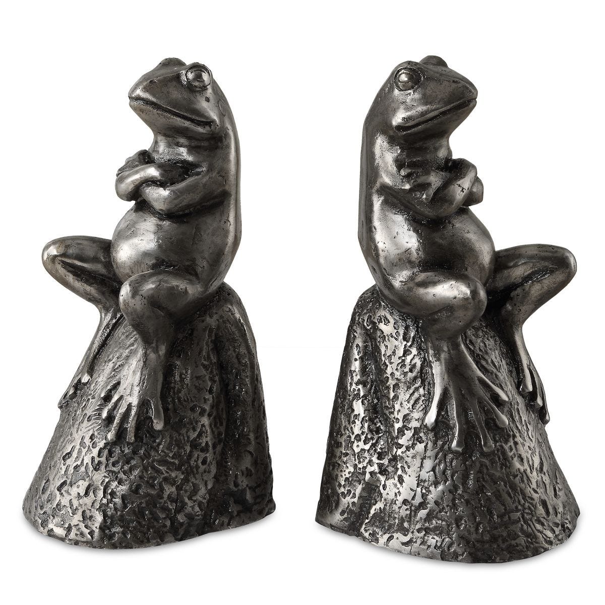 Two metallic frog bookends on a white background