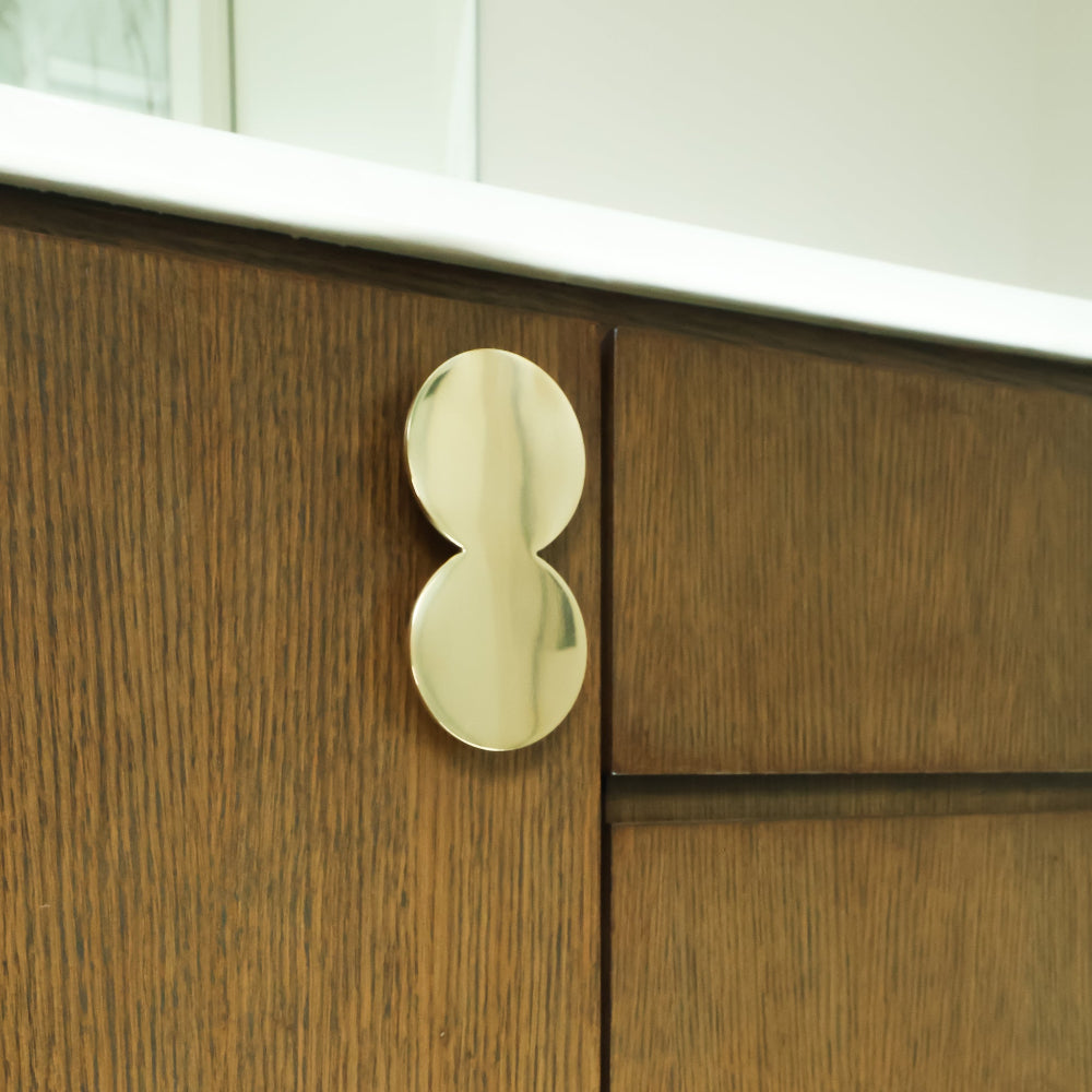 Oversized Unlacquered Polished Brass on Bathroom Cabinet Doors.