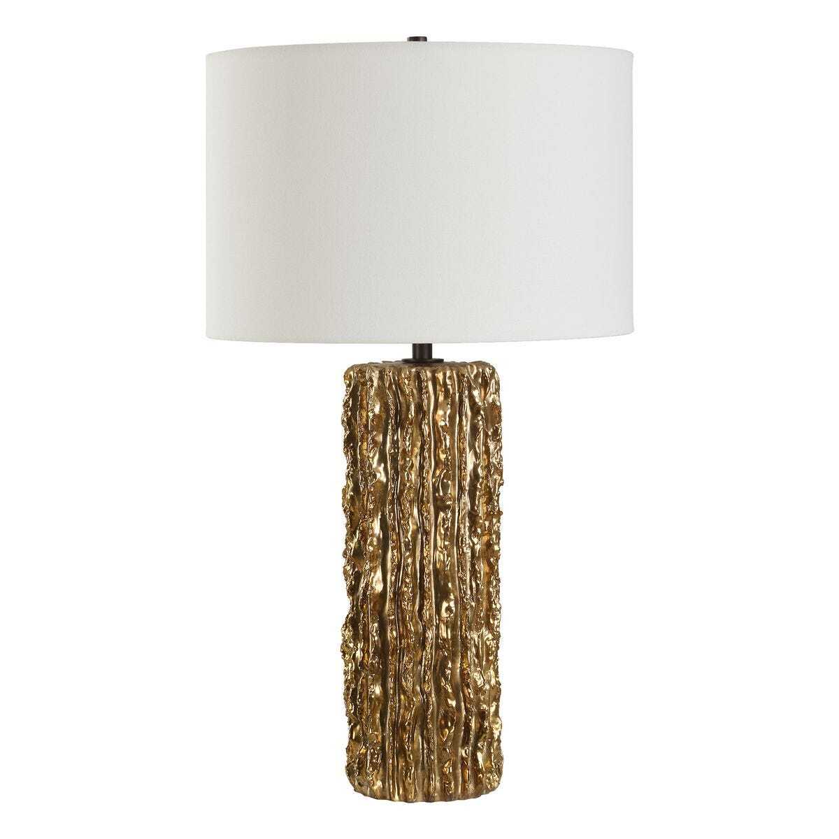 Table lamp with textured gold base and white shade on a white background
