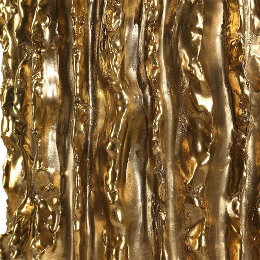 Table lamp with textured gold base and white shade on a white background