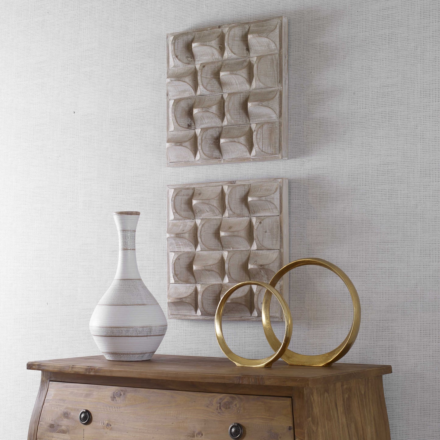 Wood Wall Art set of 2 above a wood dresser with gold decorative sculpture and white vase.