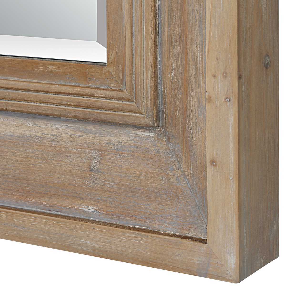 Close-up of a wooden mirror frame with a white background