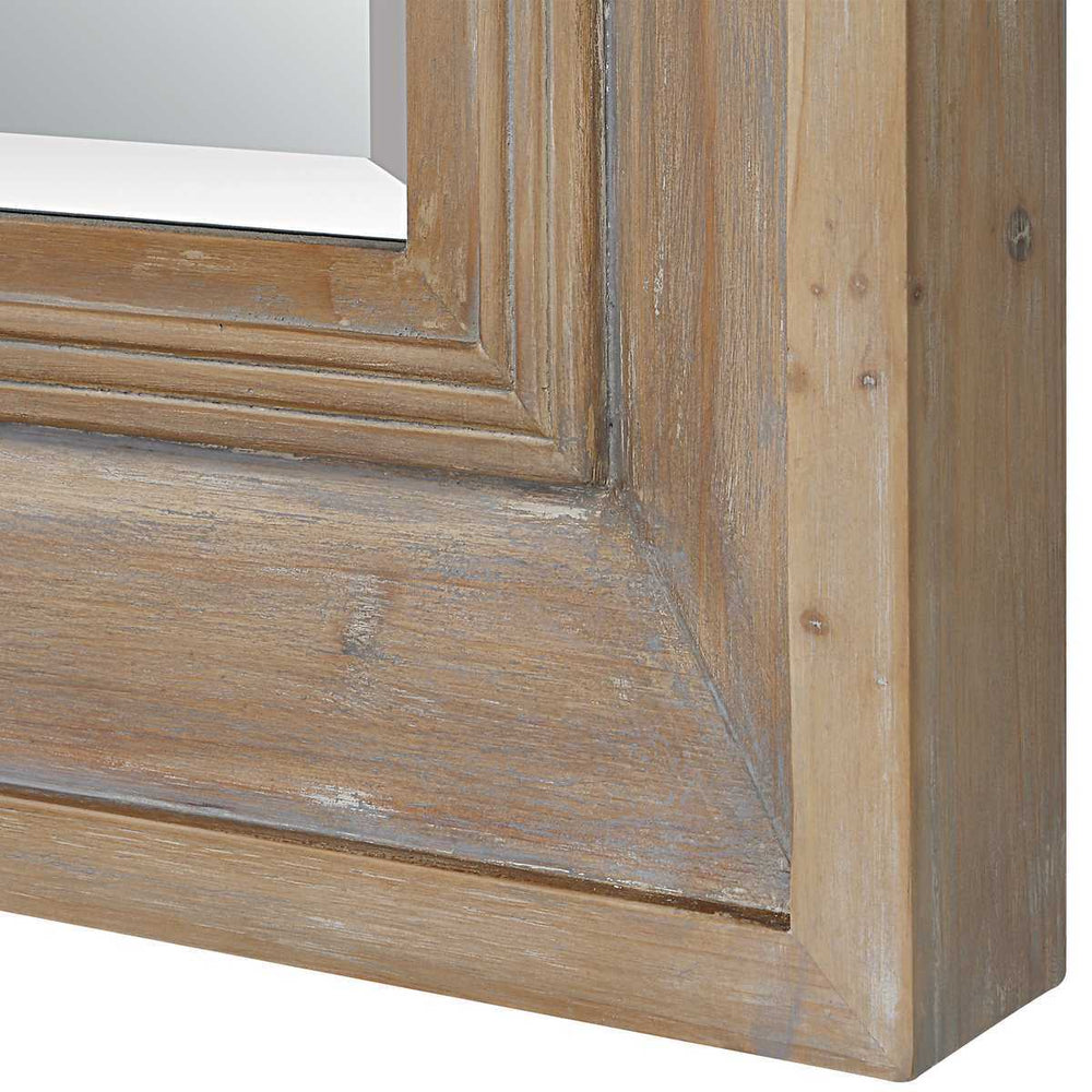 Close-up of a wooden mirror frame with a white background