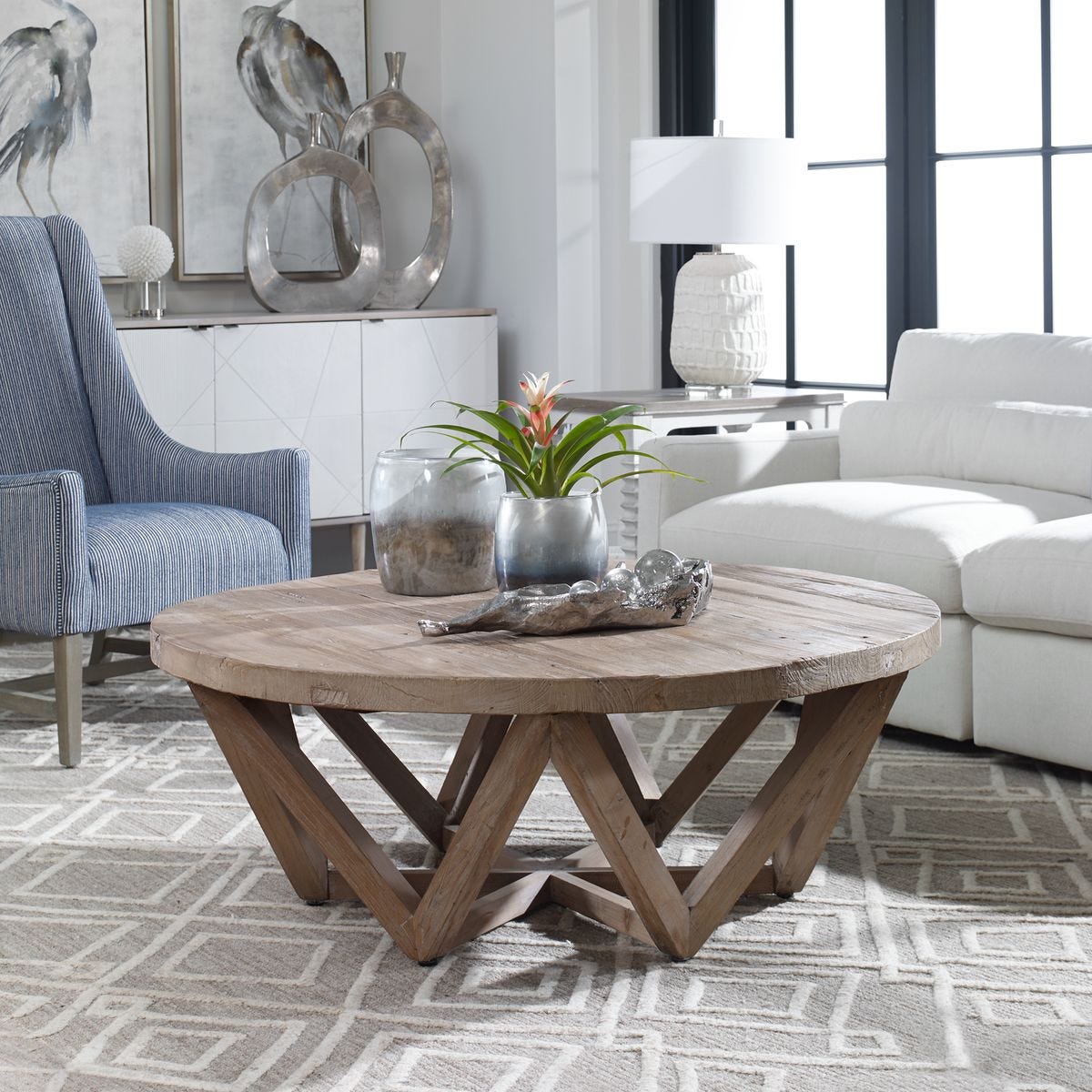 Wooden coffee table in a living room with decorative items and furniture.