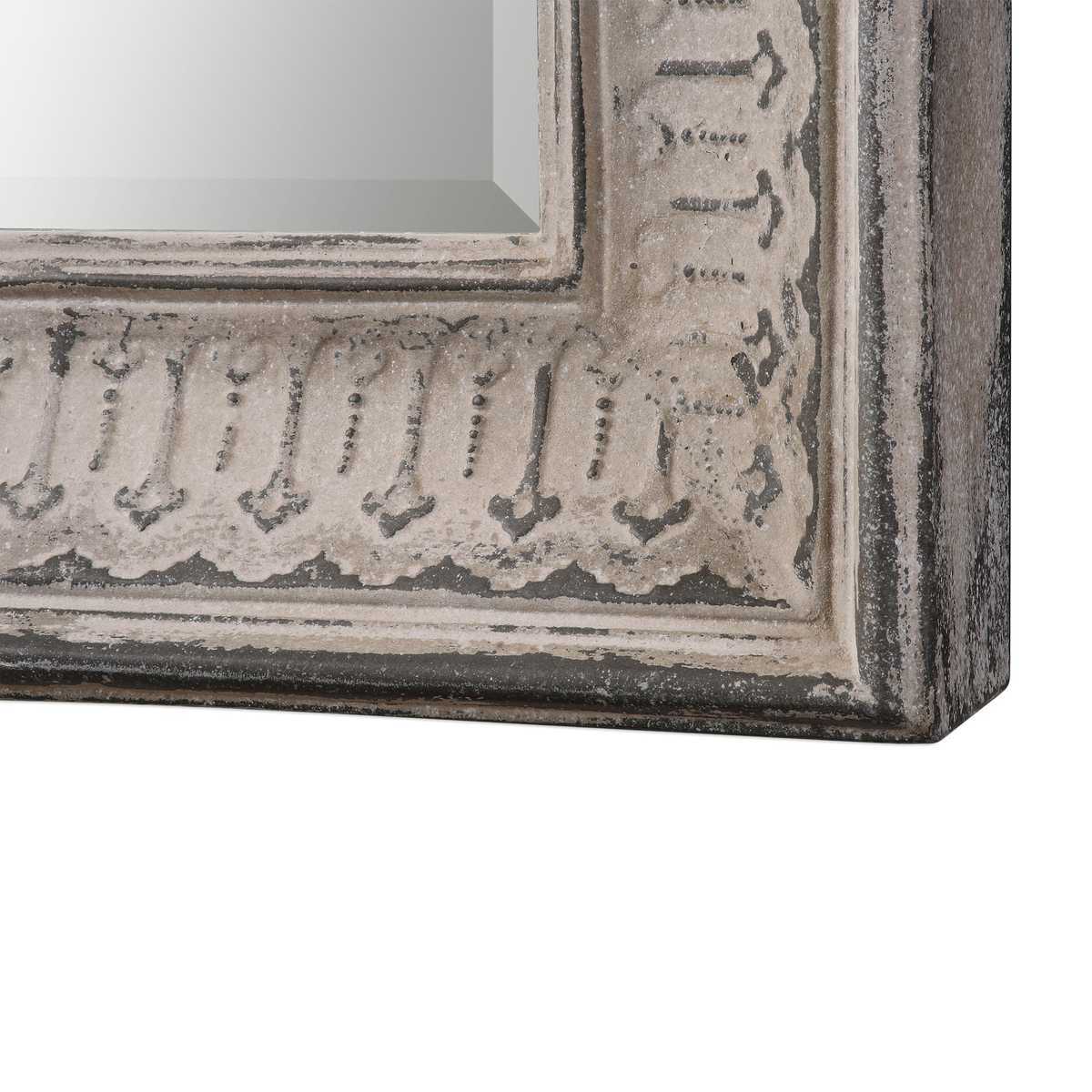 Decorative mirror with a textured frame on a white background