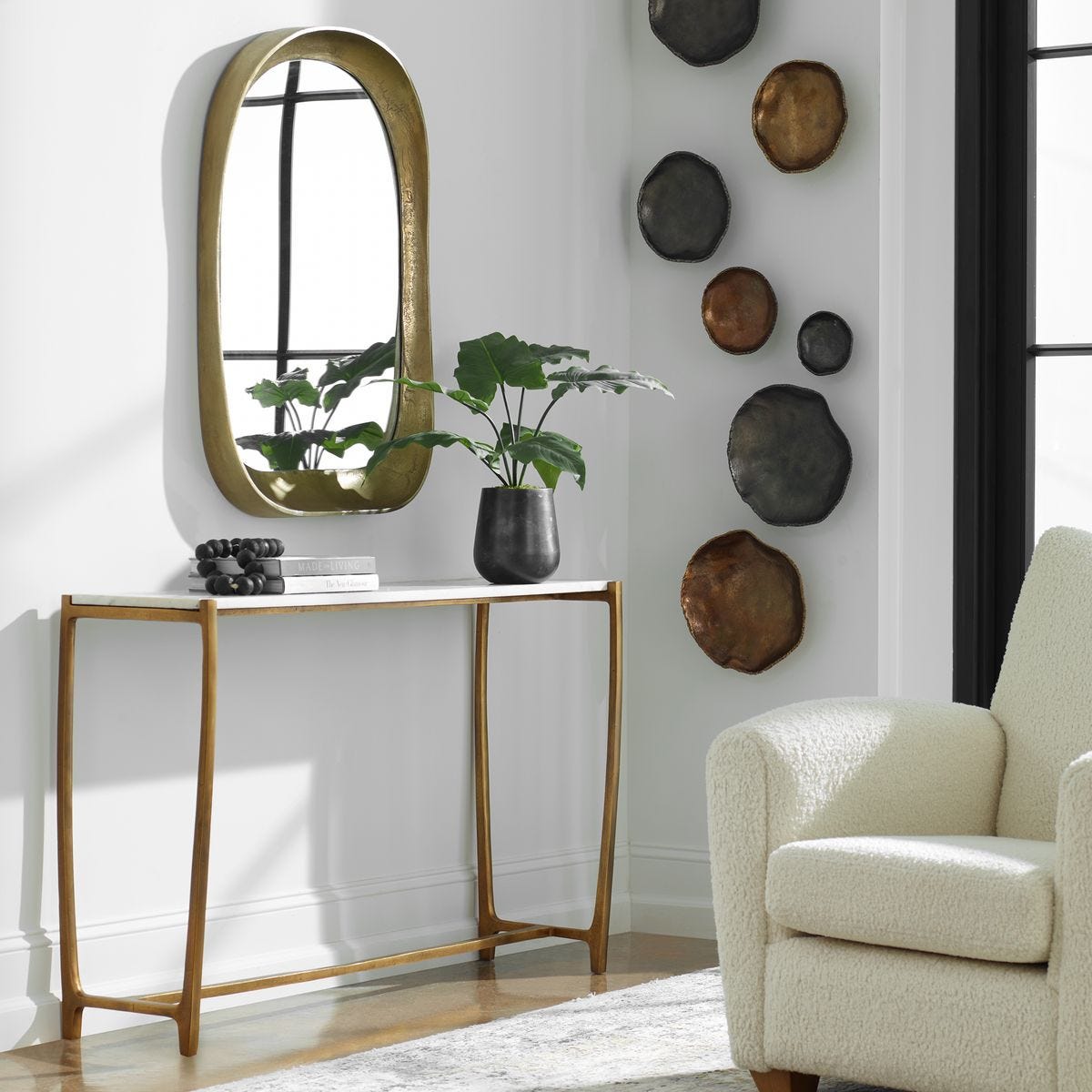 Decorative interior setting with a console table, mirror, and wall art.
