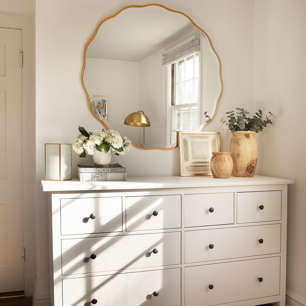 Gold Scalloped Mirror above Dresser.