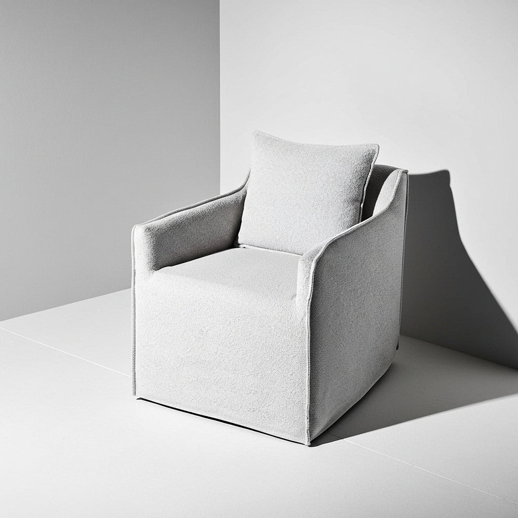 Modern gray armchair with a pillow on a neutral background