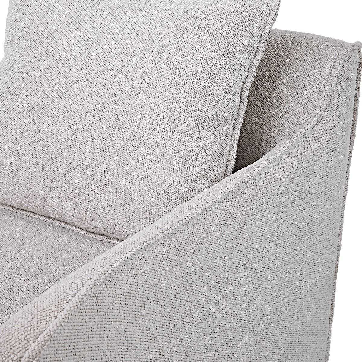 Close-up of a gray upholstered chair with fabric texture