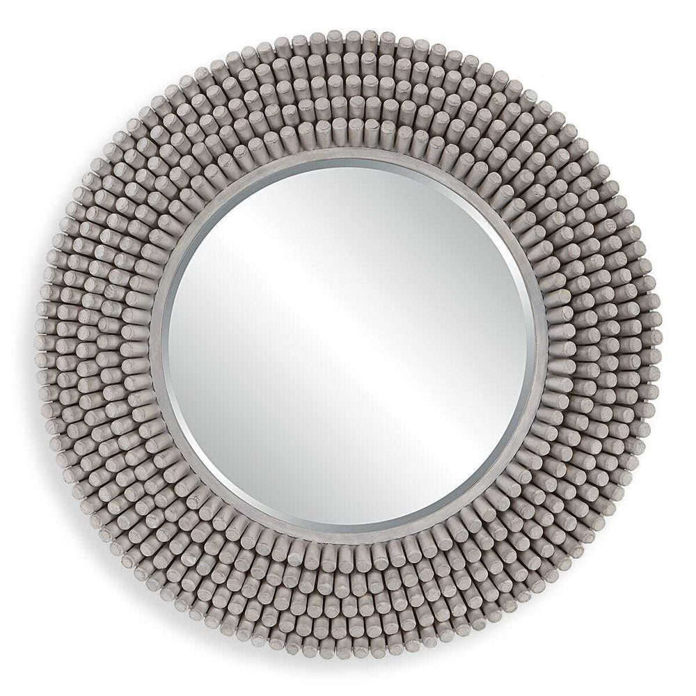Round mirror with a textured bead-like frame on a white background