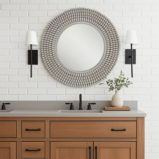 Round mirror with a textured bead-like frame on a white background