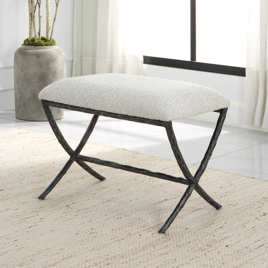 Gray contemporary bench seat in a white living room with ivory rug and concrete planter. 