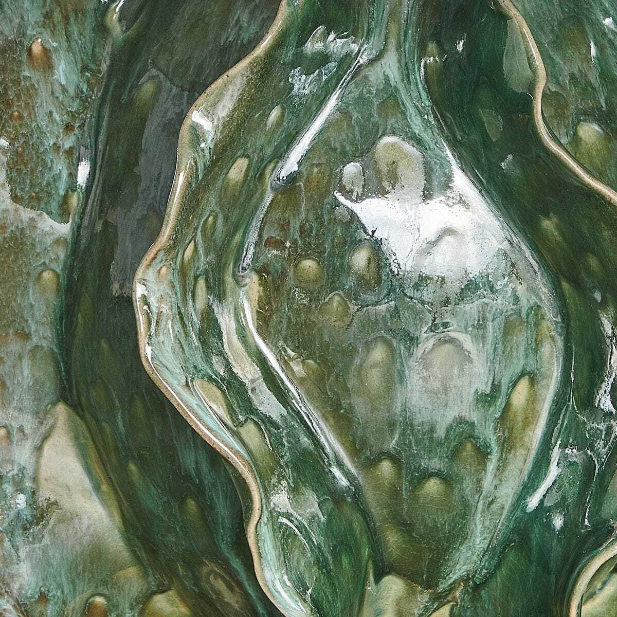 Close-up of a textured green and brown surface with a wavy pattern