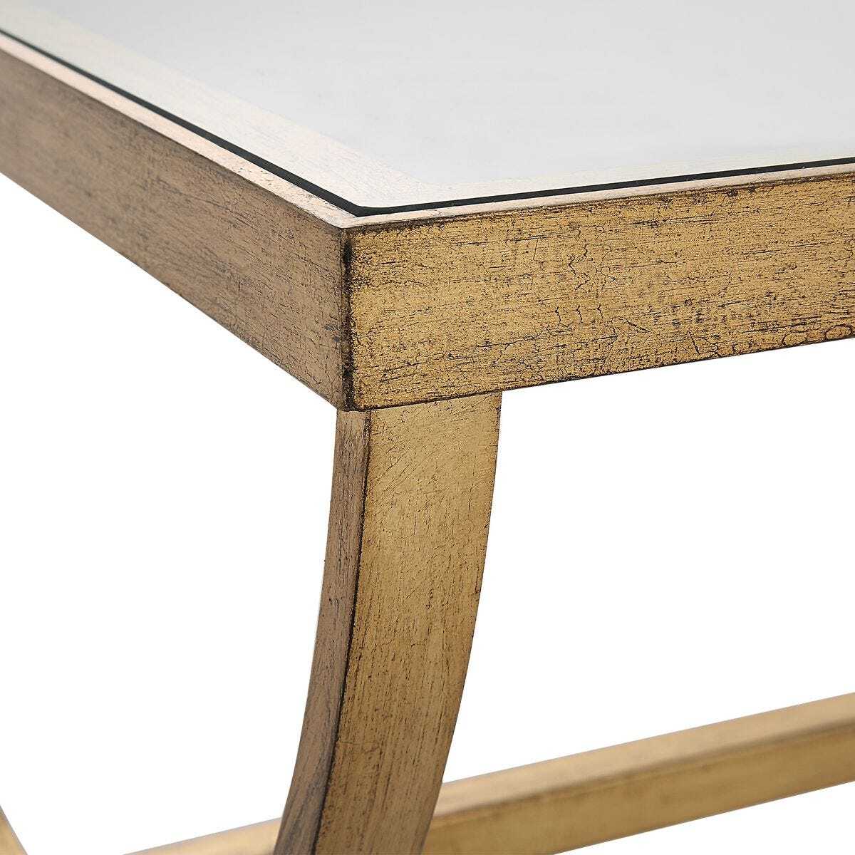 Close-up of a wooden table corner with a glass top on a white background
