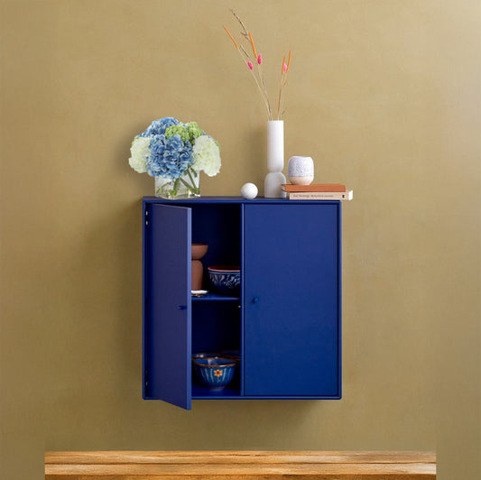 Artificial hydrangea plant on a floating blue cabinet.