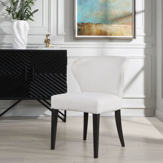 White dining chair with black wood frame set against console backdrop.