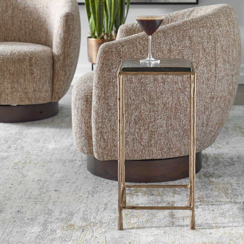 DRINK ON GOLD ACCENT TABLE NEXT TO SWIVEL CHAIR