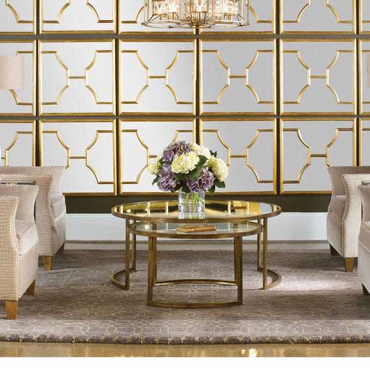 Set of two gold nesting coffee tables in a luxurious living room setting.