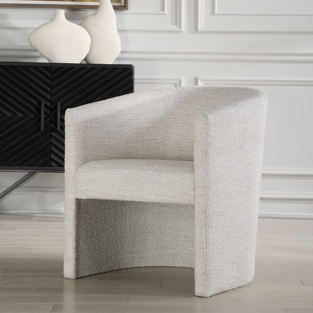 Dining Chair featuring a barrel back design and textured white boucle upholstery with console in background.