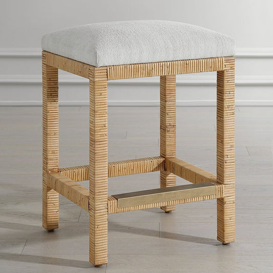 This Coastal Rattan Counter Stool has an Off-White Fabric and Antique Gold Kick Plate.