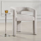 Sculptural dining chair next to a drink table.