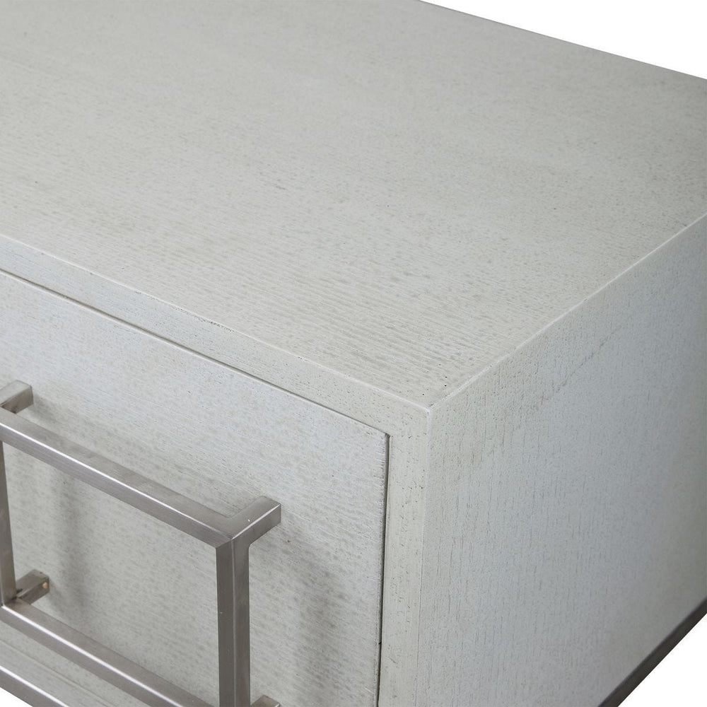 Close-up of a textured white cabinet with a metal handle on a white background