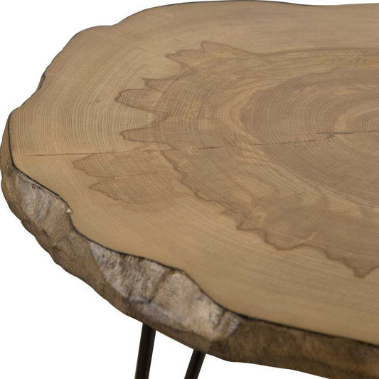 Small round table with black hairpin legs next to a chair with a cow print cushion.