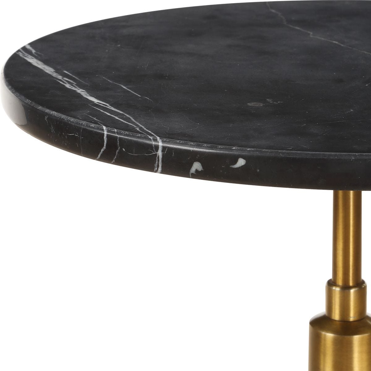 Black marble table with a gold base on a white background