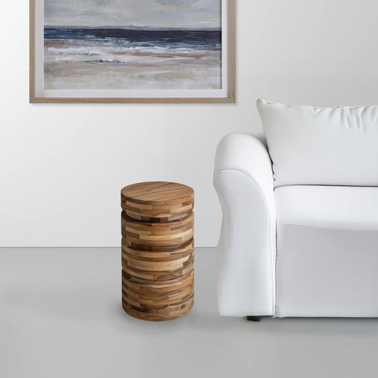 mid-century modern wood accent table at the side of a white sofa in a living room.