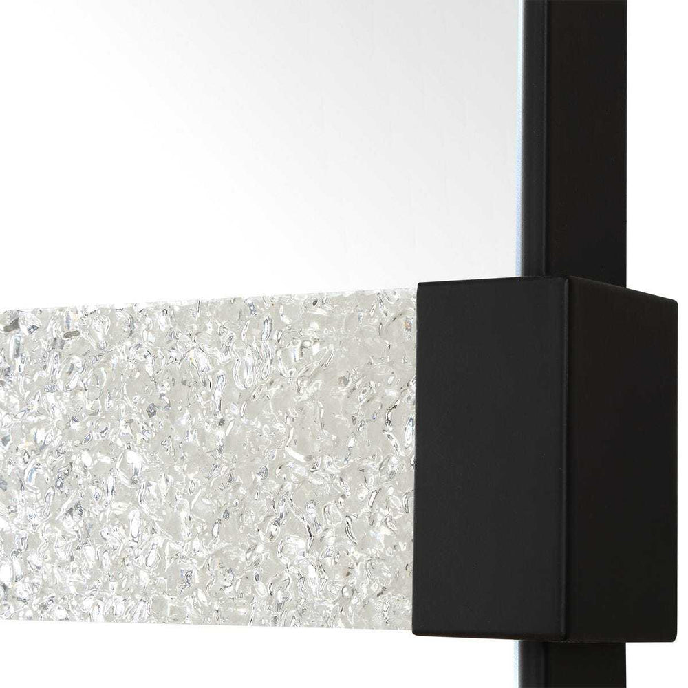 Close-up of a black rectangular object on a textured white surface