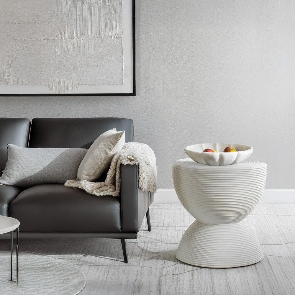 Black and white room with white decorative bowl and white side table.