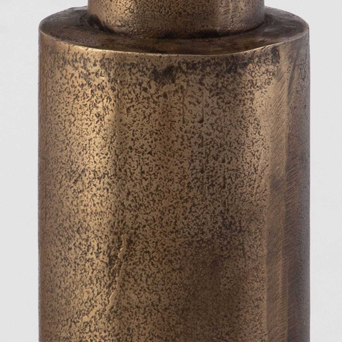 Bronze cylindrical object with textured surface on a white background