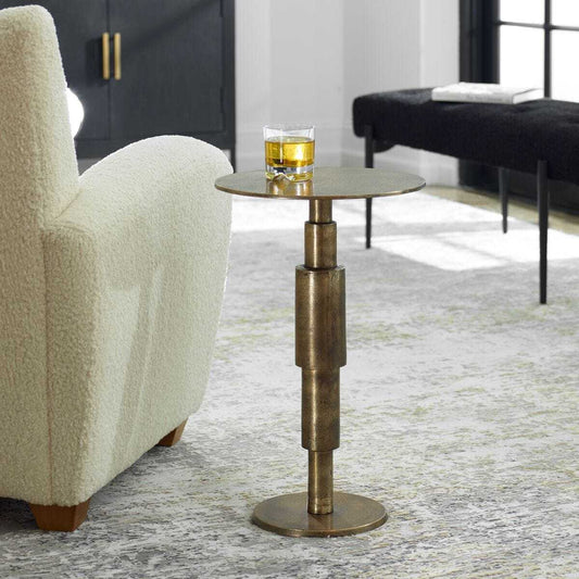 Bronze side table with a cylindrical design on a white background