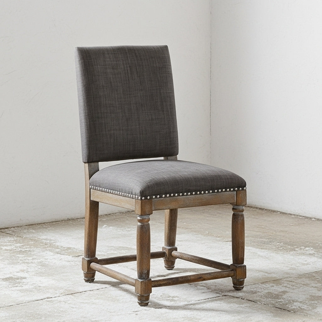 Gray upholstered chair with wooden frame on a light wooden floor.