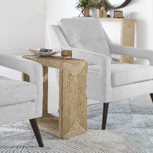 Woven narrow end table between two chairs