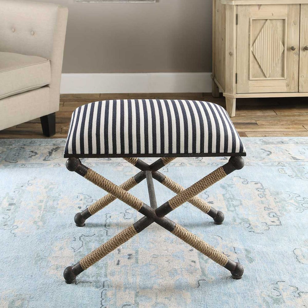 Striped stool with rope legs on a patterned rug in a room setting