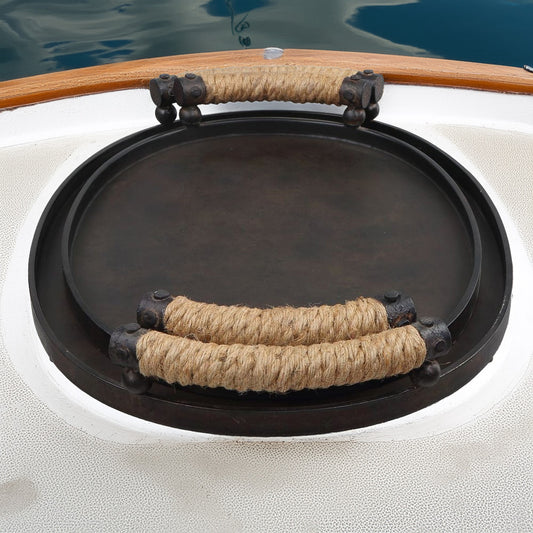 Nautical iron trays with rope handles on a boat.