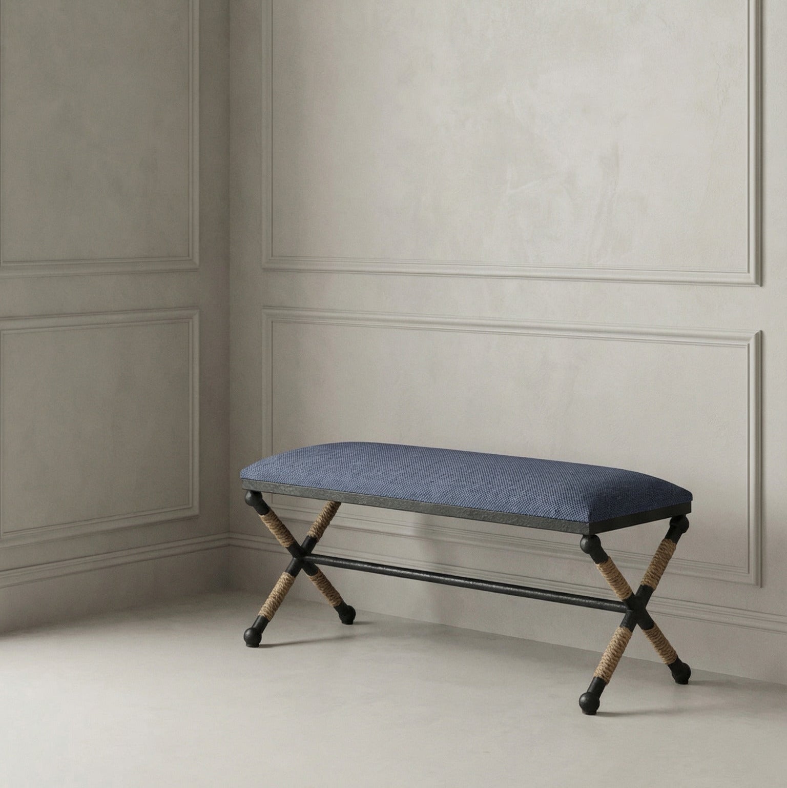 Navy bench against a gray paneled wall.