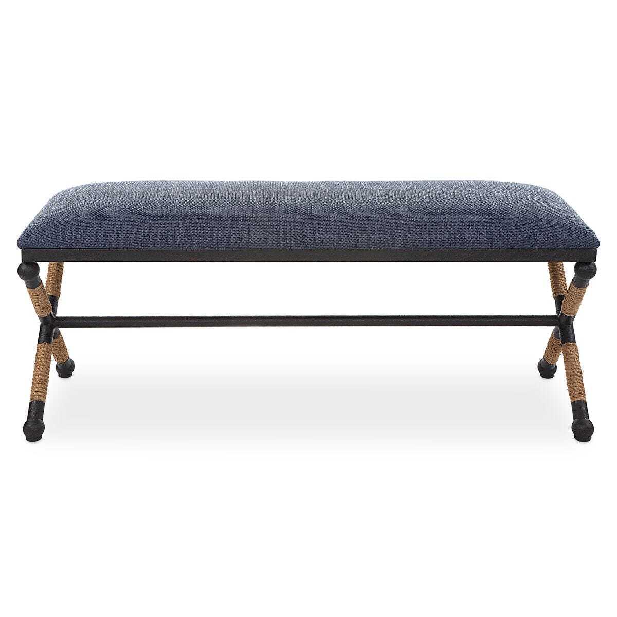 Blue upholstered bench with woven armrests on a white background