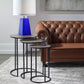 Nested side table with leather sofa and blue accent table lamp. 