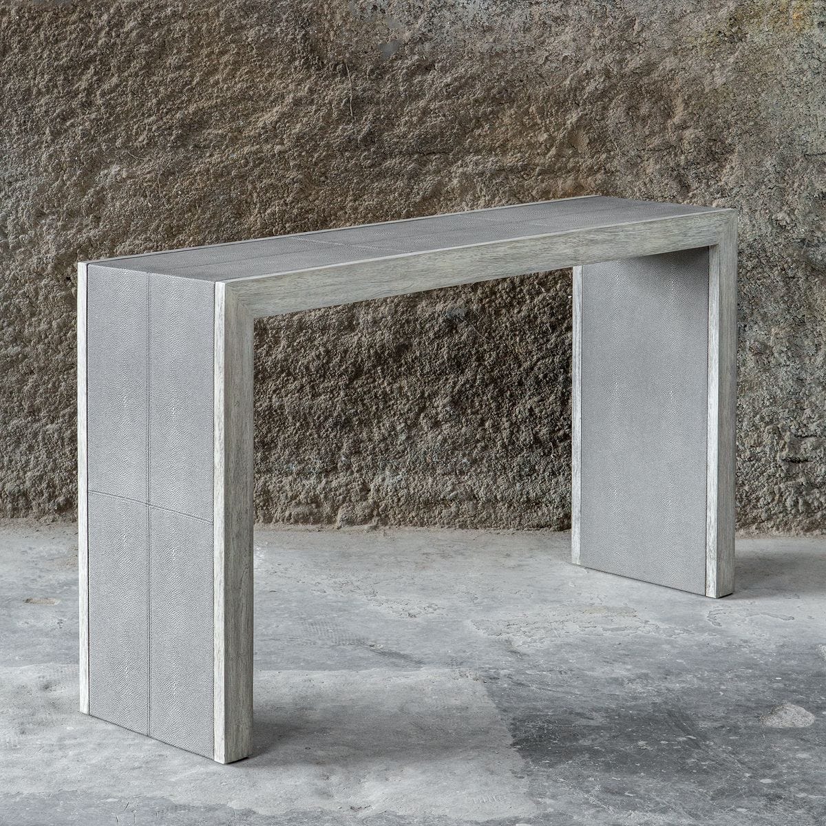 Concrete console table against a textured wall.