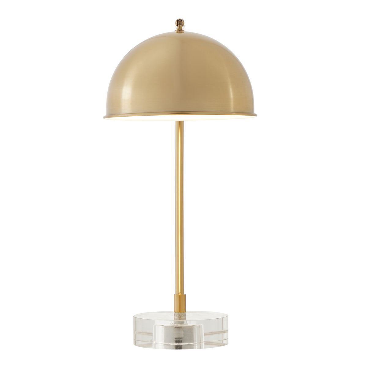 Gold table lamp with a clear base on a white background