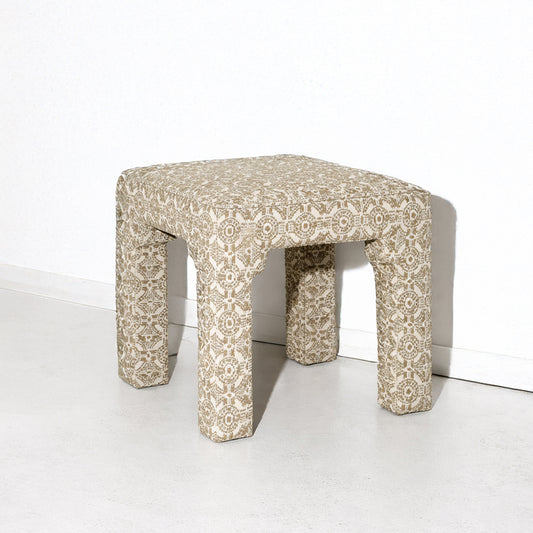 Olive green bench for closet in front of green sofa in a desert home.