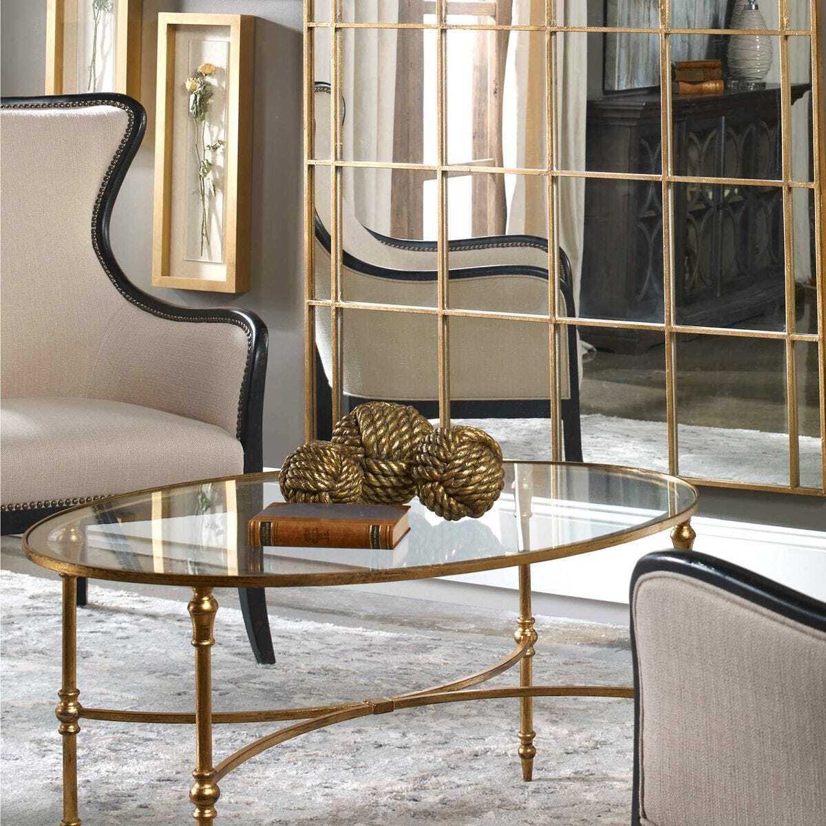 Decorative gold table with spherical ornaments in a stylish room.