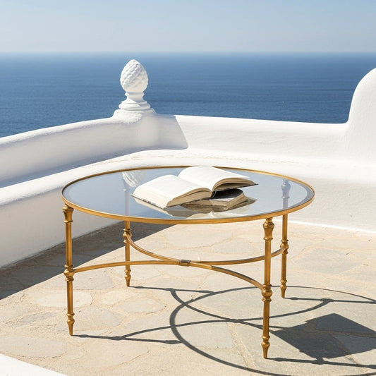 Round glass table with gold metal frame on a white background