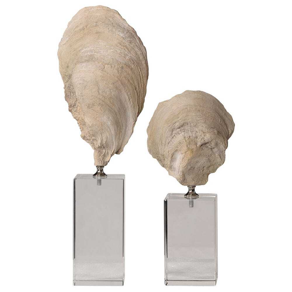 Two large oyster shell sculptures on metallic stands against a white background